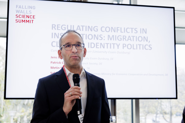 J.M. Gurr presenting at 'Regulating Conflicts in Institutions' panel at 'Falling Walls Science Summit'