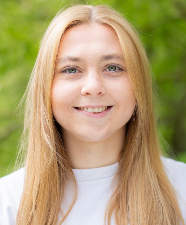 Portrait of a white woman smiling at the camera