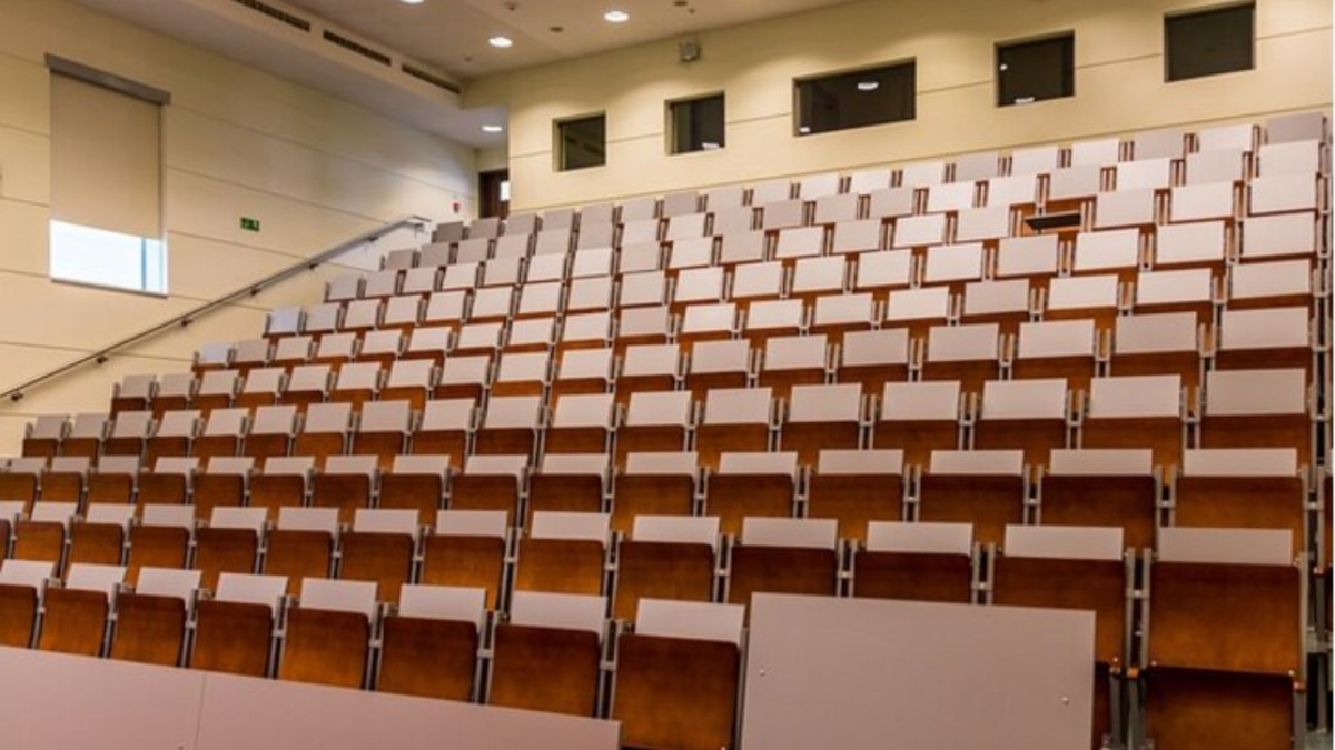 Ein Hörsaal mit lehren Sitzreihen.