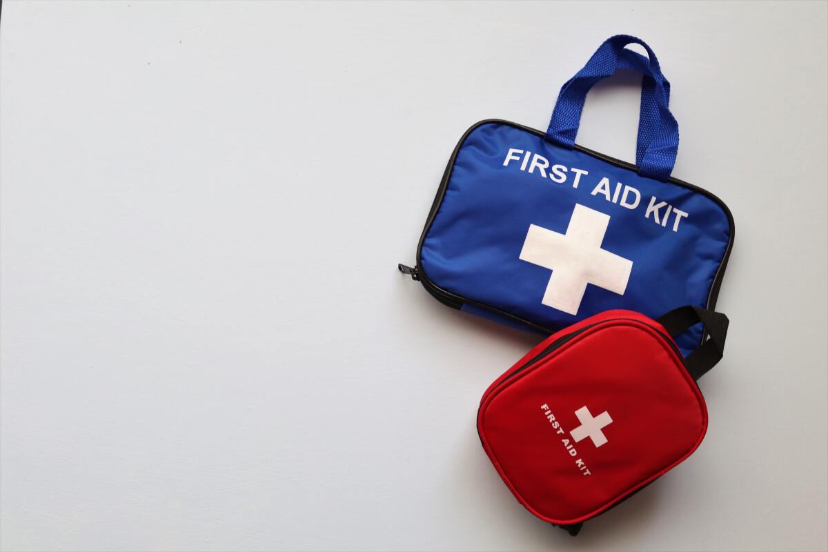 Two small first aid kits lying on a white background.