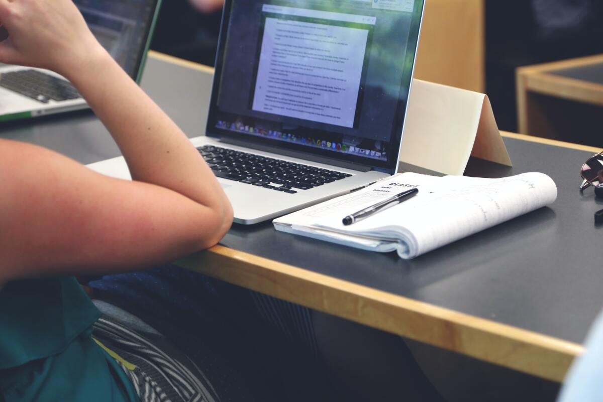 A woman sitting in front of a laptop.